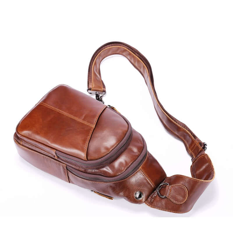 Brown leather casual crossbody bag for men, featuring a minimalist design and adjustable strap.
