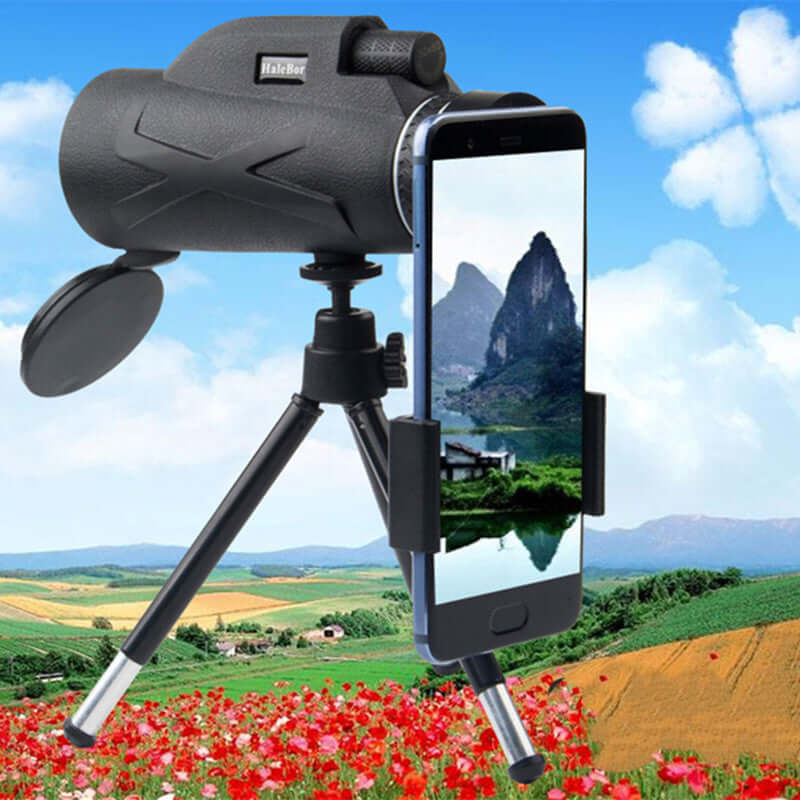 Outdoor monocular telescope with smartphone holder, ideal for night vision and astronomy, showcasing scenic landscape.