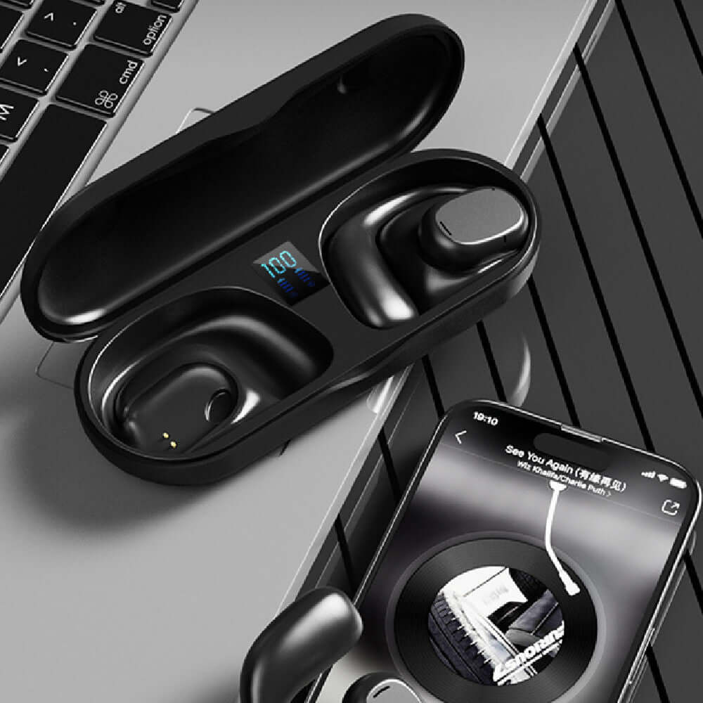 Wireless sports headphones in black case with digital display, charging on a laptop and smartphone, showcasing sleek design.