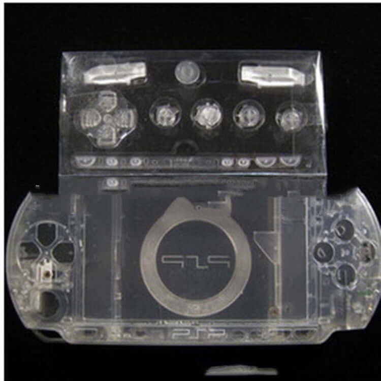 Transparent protective housing for PSP1000 handheld gaming console, showcasing buttons and controls.