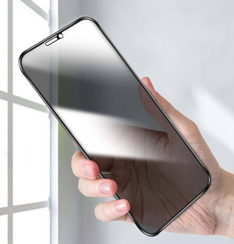 Hand holding a tempered glass screen protector for iPhone, showcasing its anti-peeping feature and sleek design.
