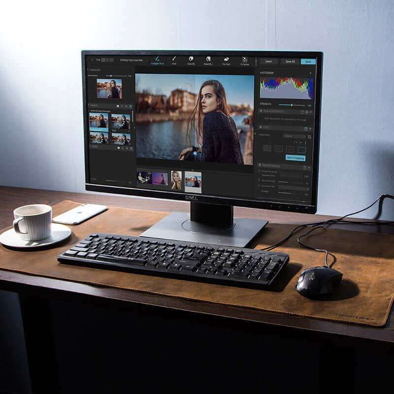 Extra large non-slip leather desk pad on a desktop with a computer, keyboard, mug, and mouse.