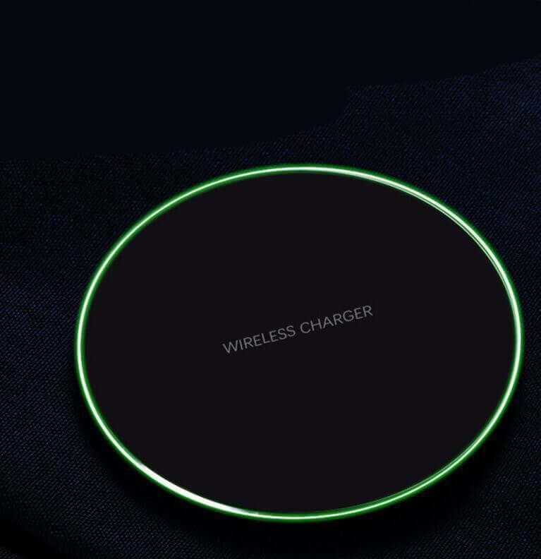Wireless fast charge charger with green LED light, minimalistic design, ideal for quick device charging.