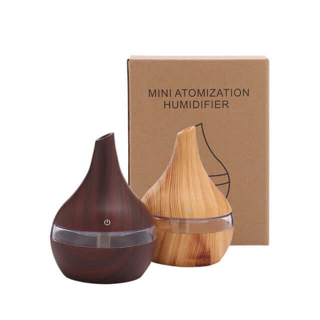 Wood grain mini humidifier set with light and deep wood finishes next to packaging, ideal for home use.
