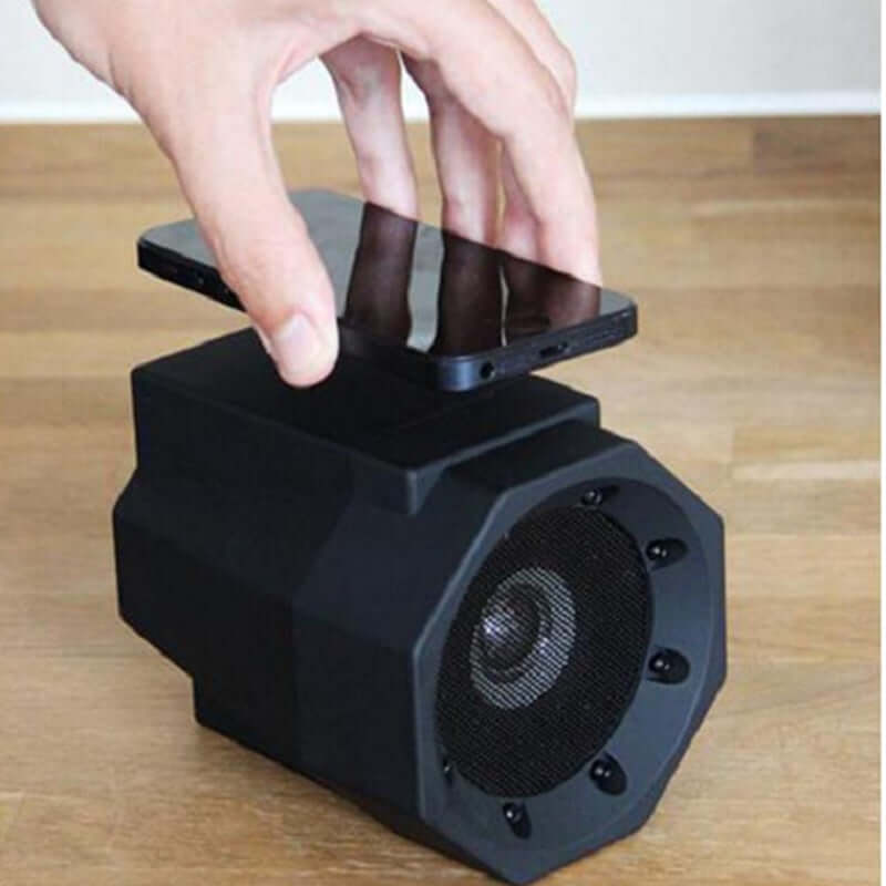Smart magnetic induction resonance speaker with a smartphone placed on top for enhanced audio.