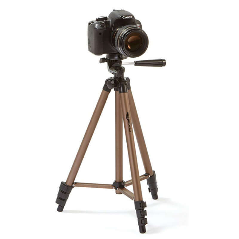 Canon camera mounted on a brown tripod, showcasing stability for photography and videography.