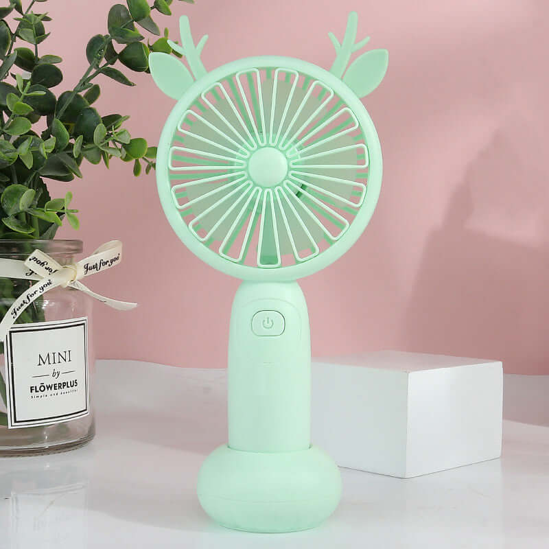 Portable mint green mini electric fan with deer antlers, suitable for cooling on-the-go.