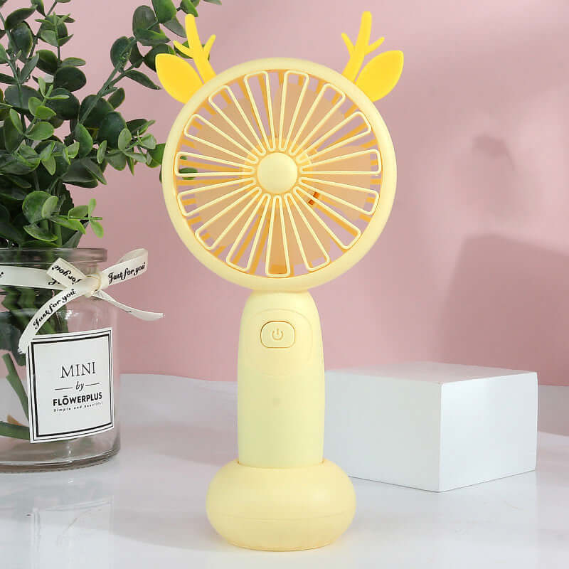 Mini handheld USB fan in yellow with cute deer antlers, perfect for portable cooling and adjustable wind speed.
