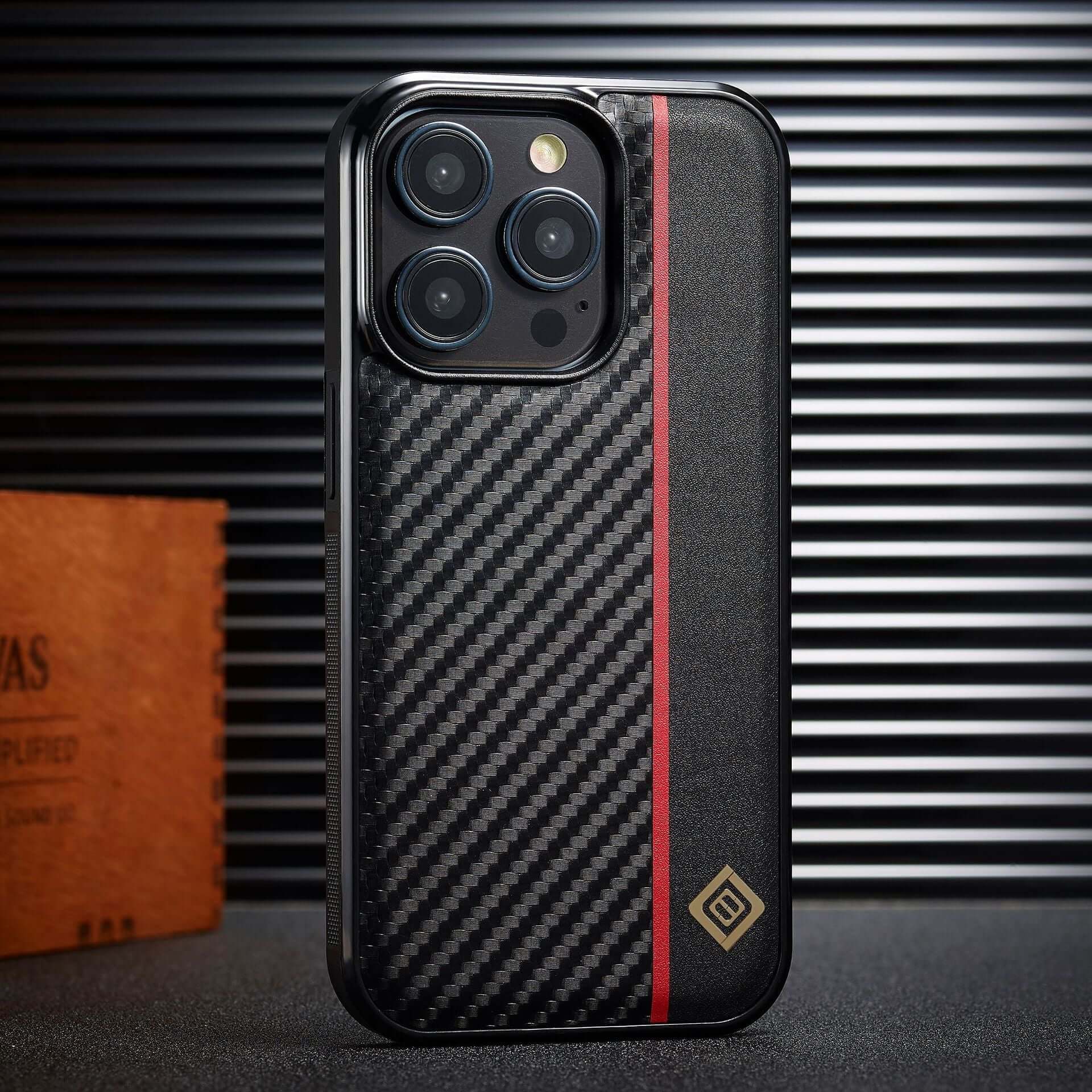Sleek black carbon fiber phone shell with red stripe, designed for iPhone, offering anti-fall protection and stylish business appeal.