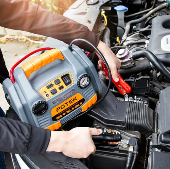 User connecting POTEK portable power source to car battery for jump starting, showcasing its high performance and convenience.