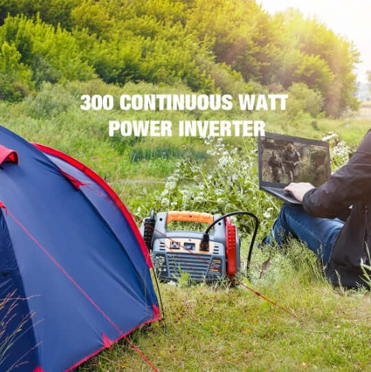 User operating a laptop connected to a 300-watt power inverter near a camping tent in nature.