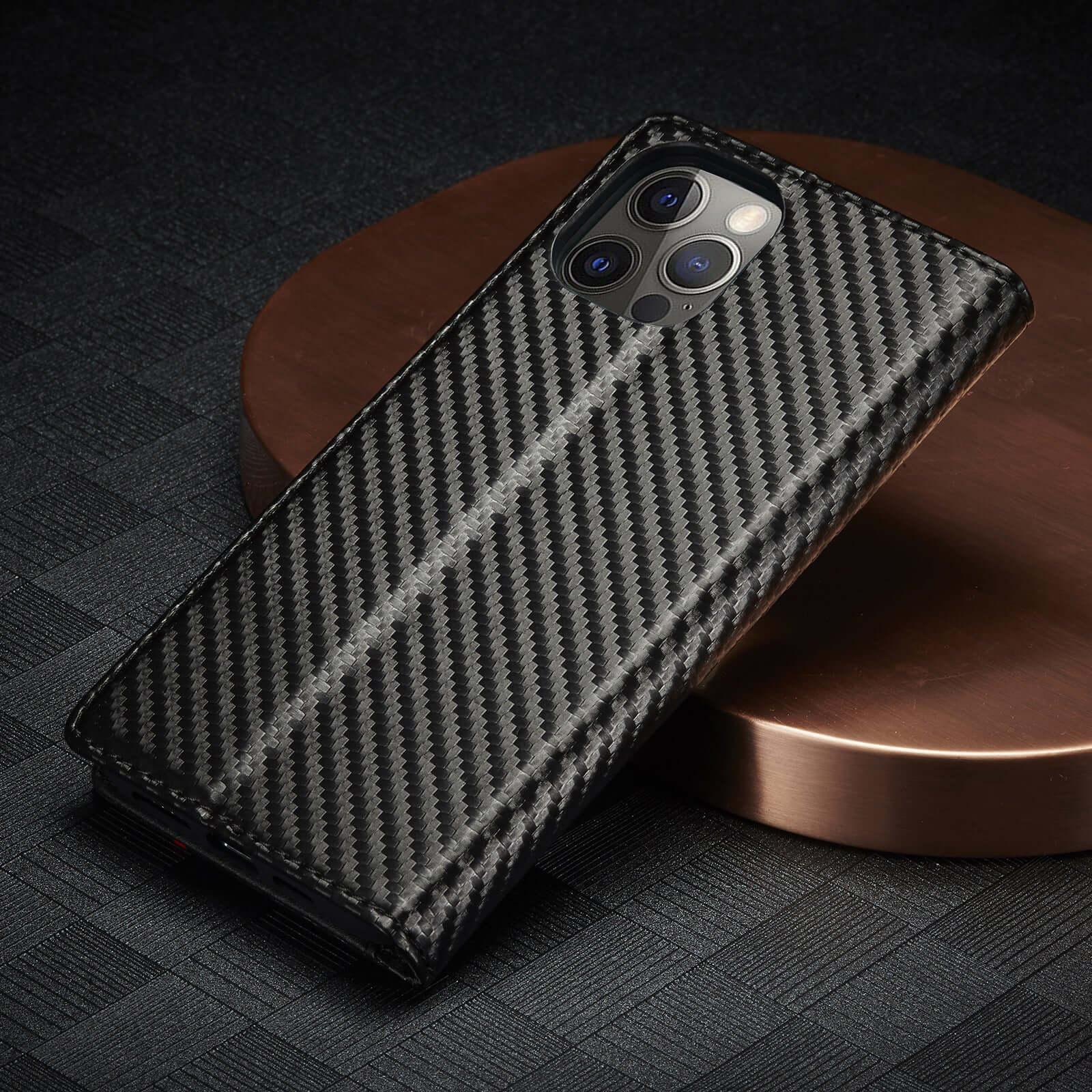 Trendy leather case with carbon fiber texture, designed for Apple phones, featuring a magnetic flip style and handmade details.