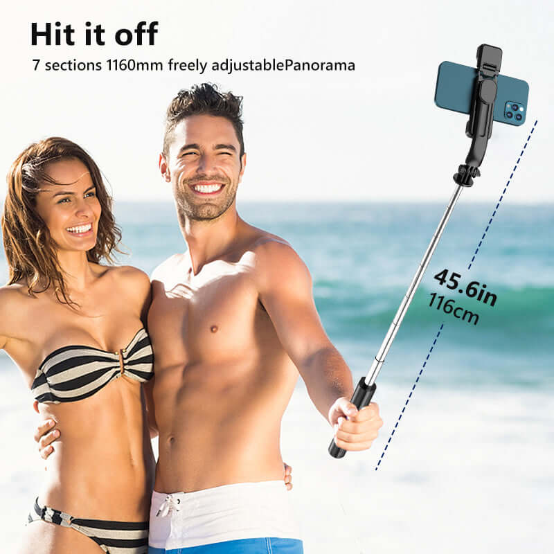 Couple using a Bluetooth selfie stick tripod on the beach, showcasing adjustable length and smartphone compatibility.