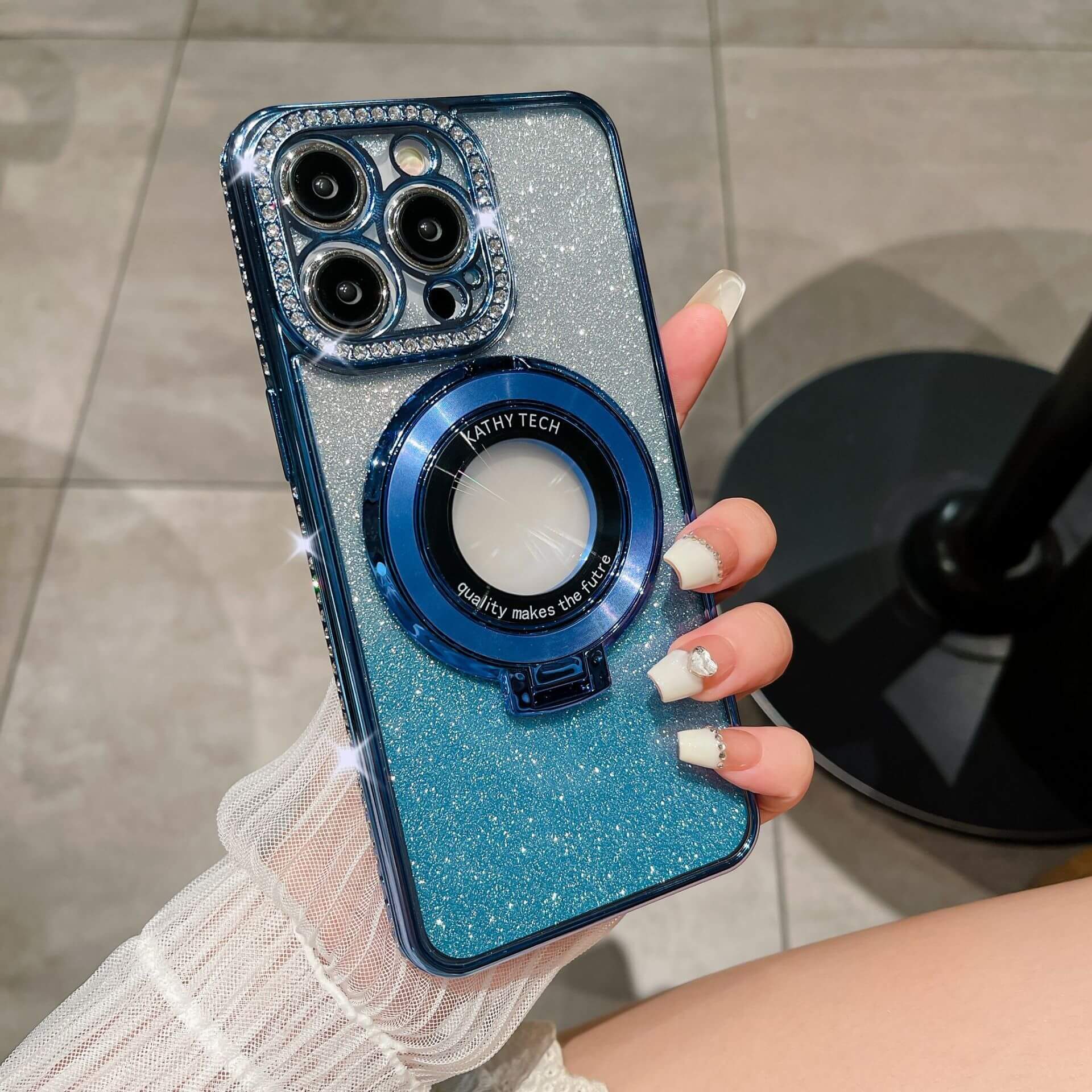 Glitter TPU electroplating magnetic bracket phone case in hand, featuring blue hues and a sparkling design.