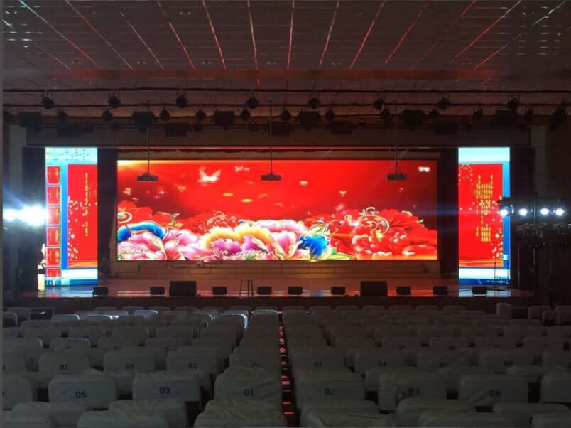 P3 indoor full-color HD LED display rental screen in event hall showcasing vibrant graphics and lighting.