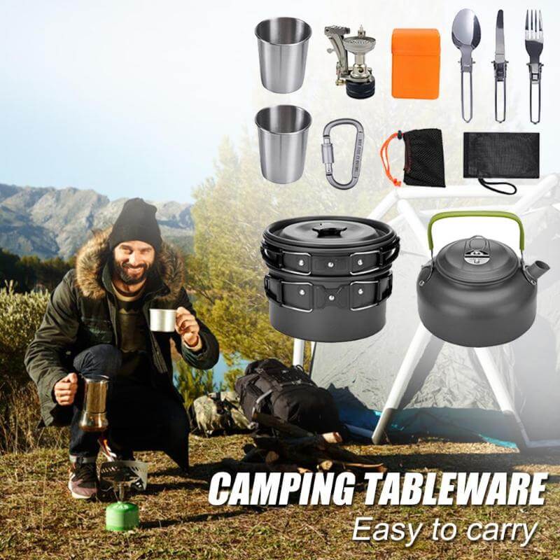 Man enjoying camping with portable cooking set including pots, cups, utensils, and teapot in a scenic outdoor setting.