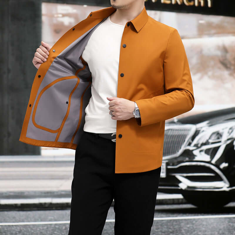 Man wearing a stylish orange jacket, showcasing the interior lining, set against an urban backdrop.