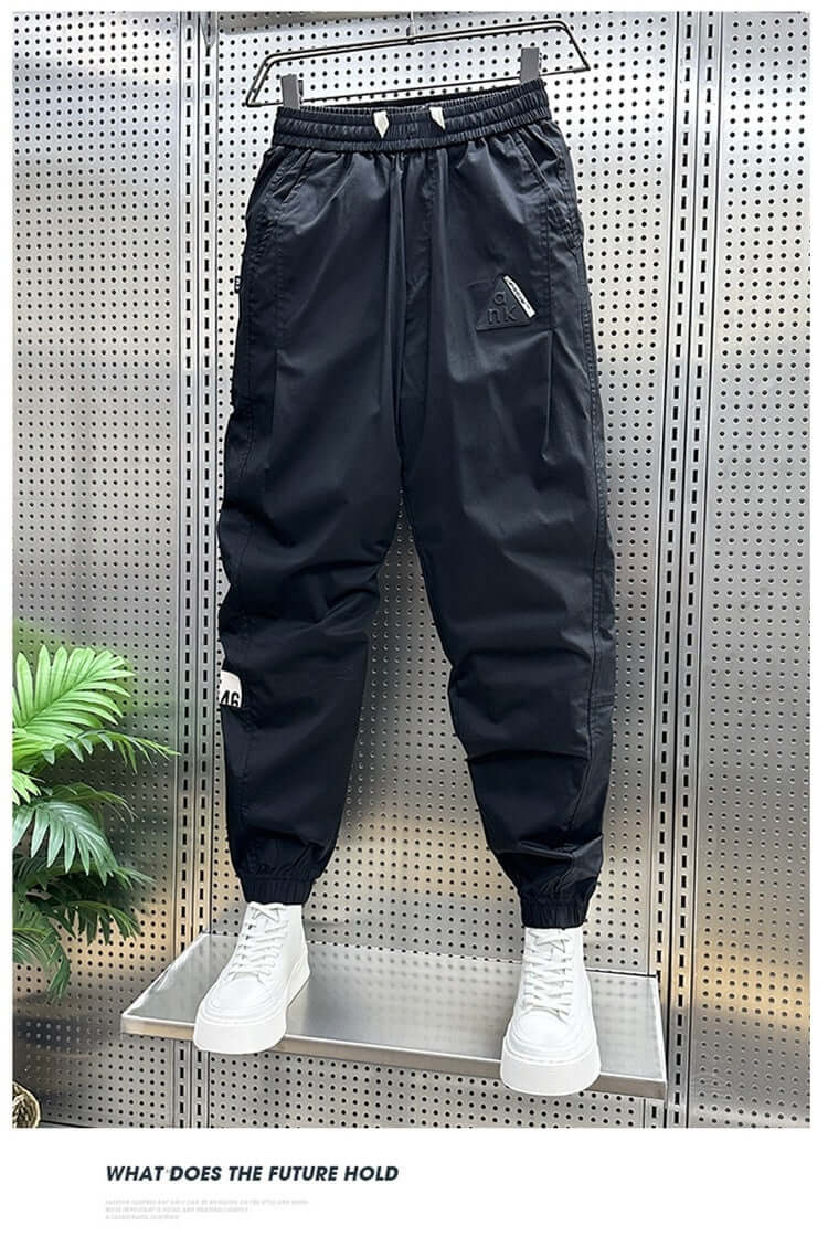 Black ankle-banded leisure pants for men, featuring drawstring waist and cropped design, ideal for summer outings.