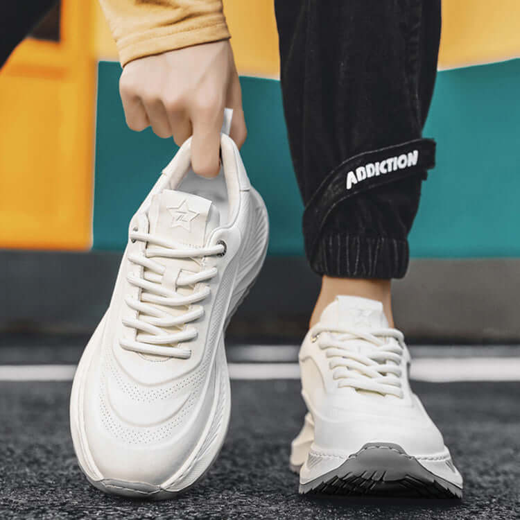 Stylish white lace-up sports shoes with thick soles, perfect for casual and athletic wear.