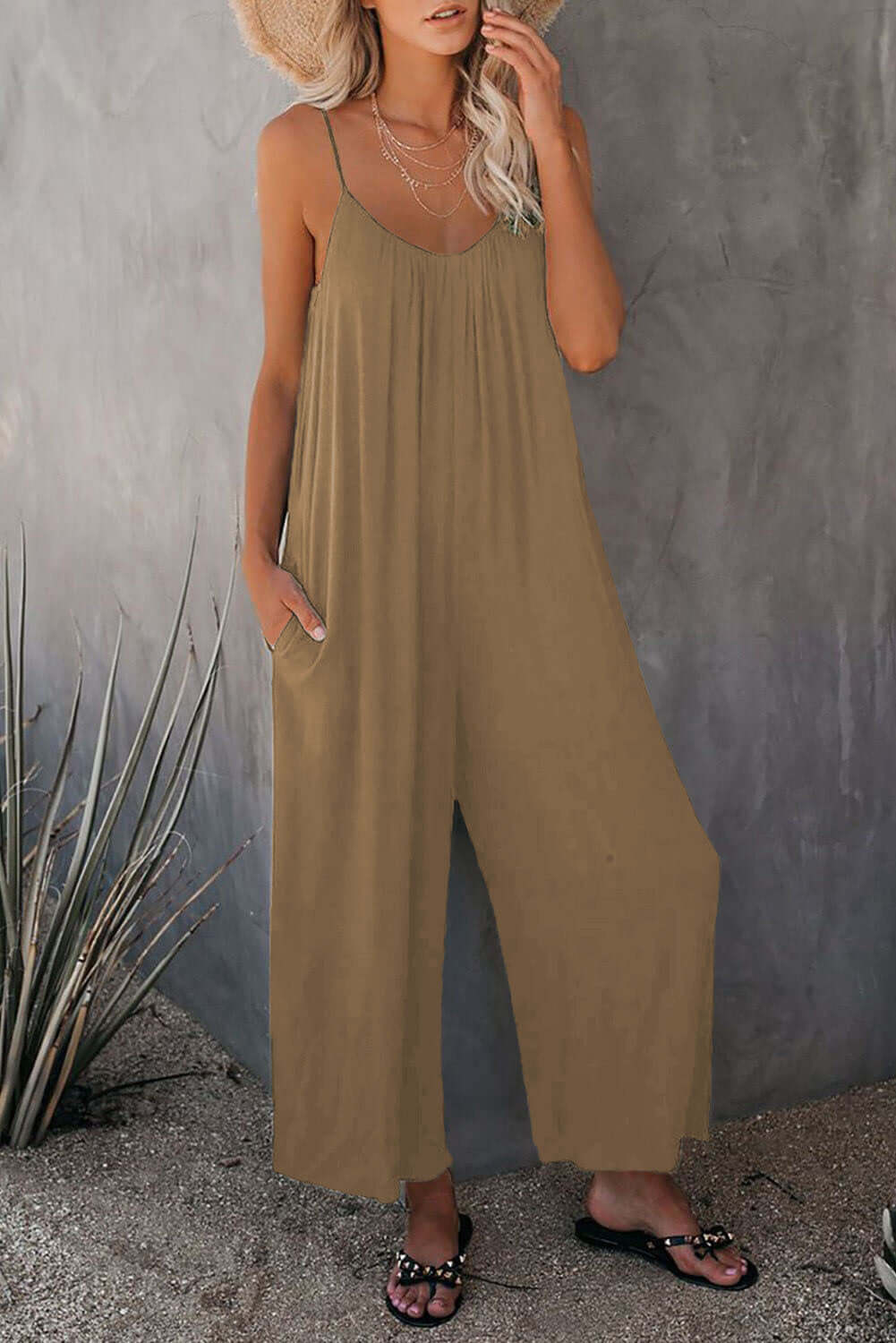 Women's loose khaki sleeveless jumpsuit with pockets, perfect for summer casual wear.