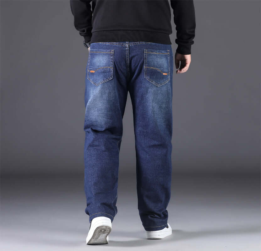 Men's casual loose-fitting denim pants in blue, shown from the back with a minimalist style.