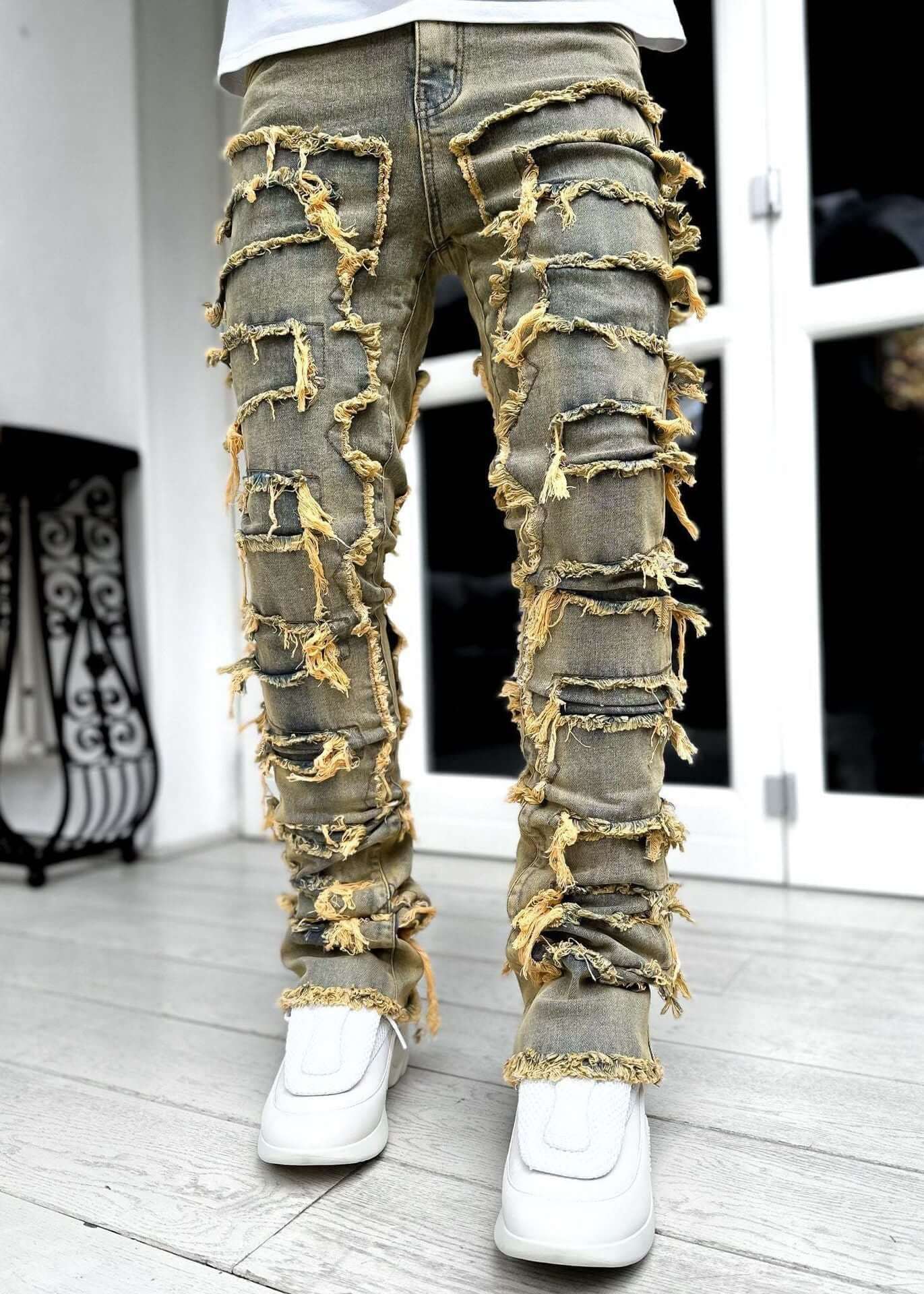 Men's individual patched jeans with a stylish ripped design, perfect for casual fashion.