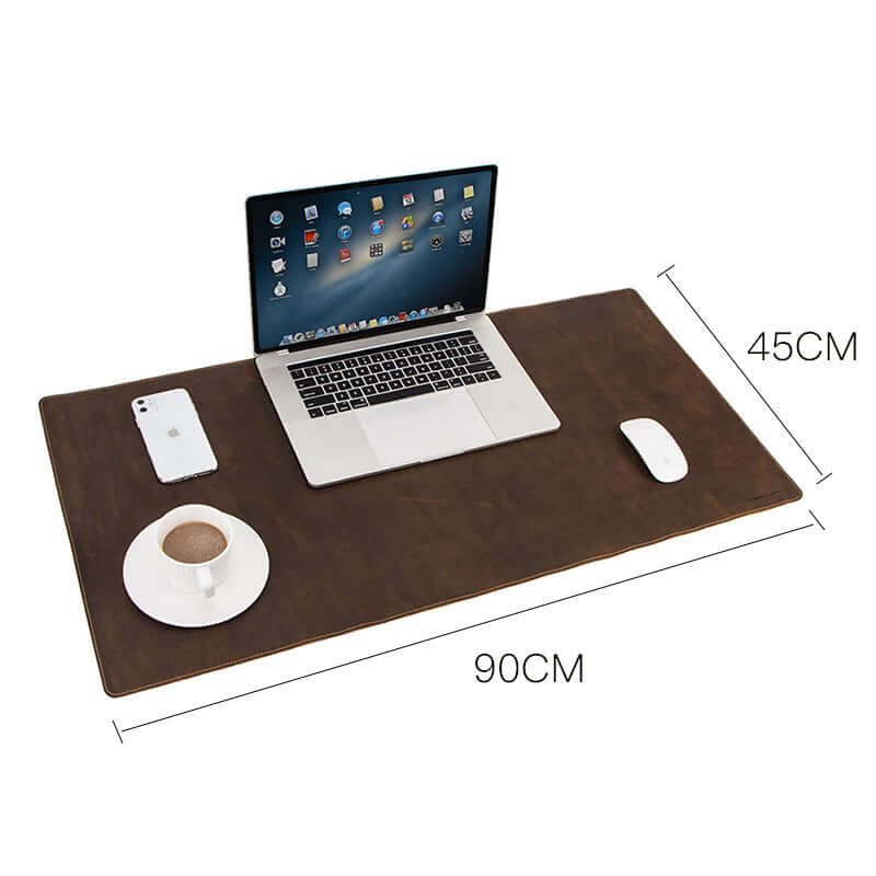 Extra large non-slip leather desk pad measuring 90x45cm with laptop, mouse, and coffee cup on a retro workspace.