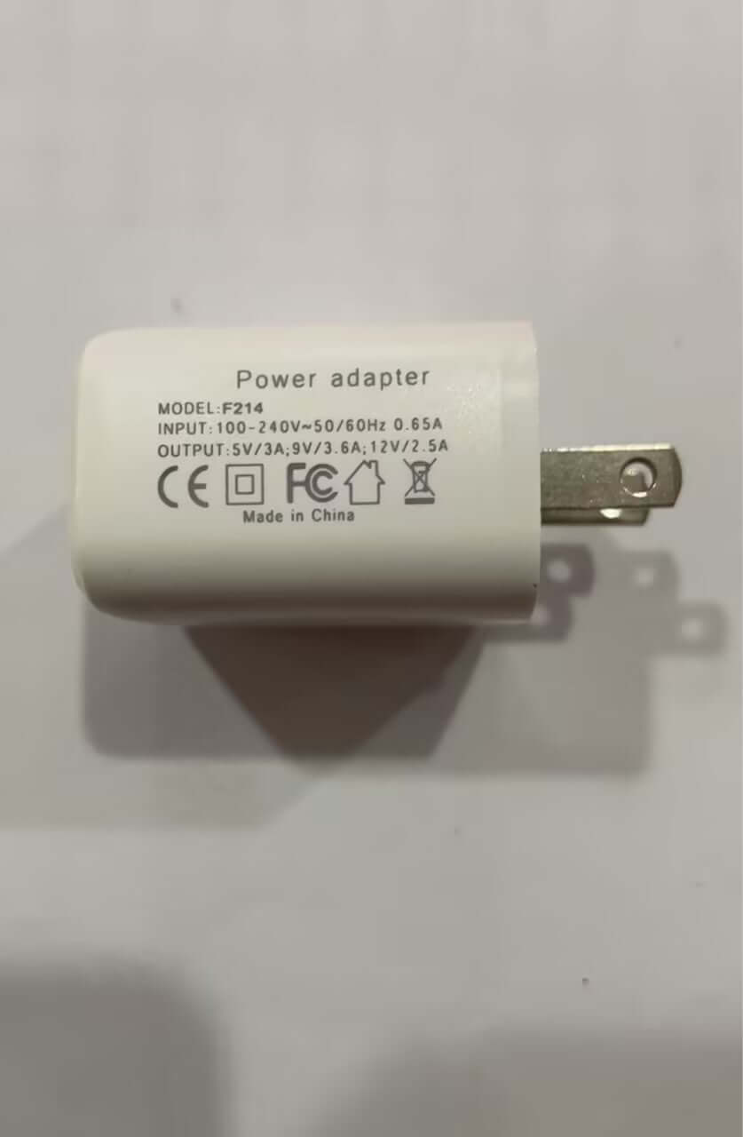 White power adapter with model number F214, input 100-240V, output specifications visible.