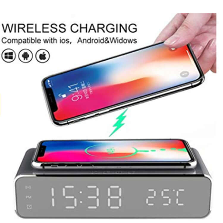 Wireless charging thermometer alarm clock displaying time and temperature with a smartphone charging on top.