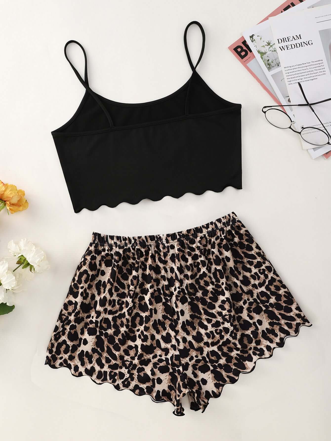 Leopard print shorts with a black scalloped crop top, perfect for leisure and home wear.