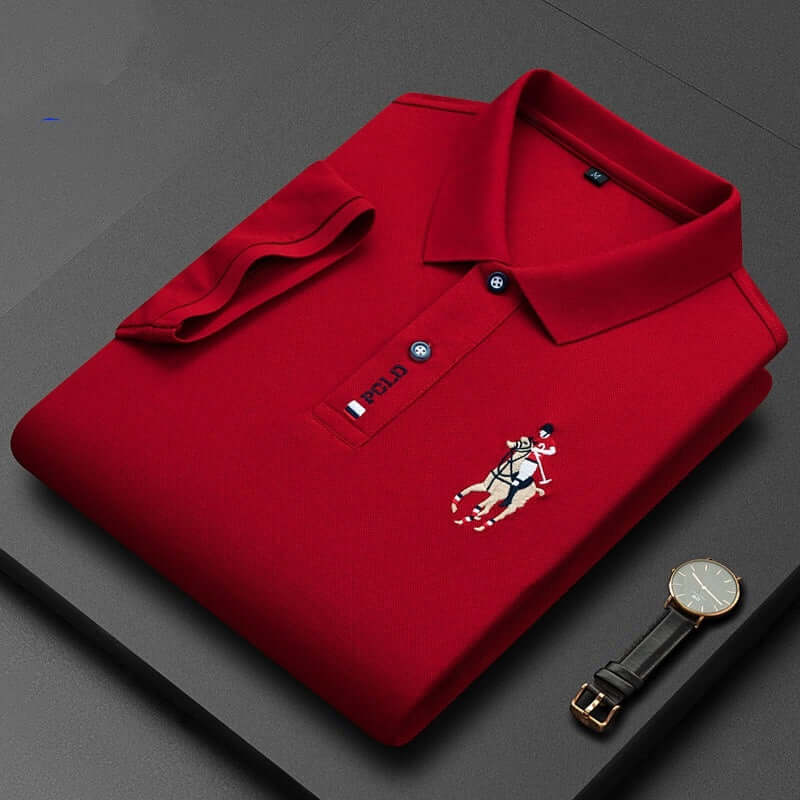 Red men's polo shirt with a lapel and embroidered logo, styled with a watch on a black surface.