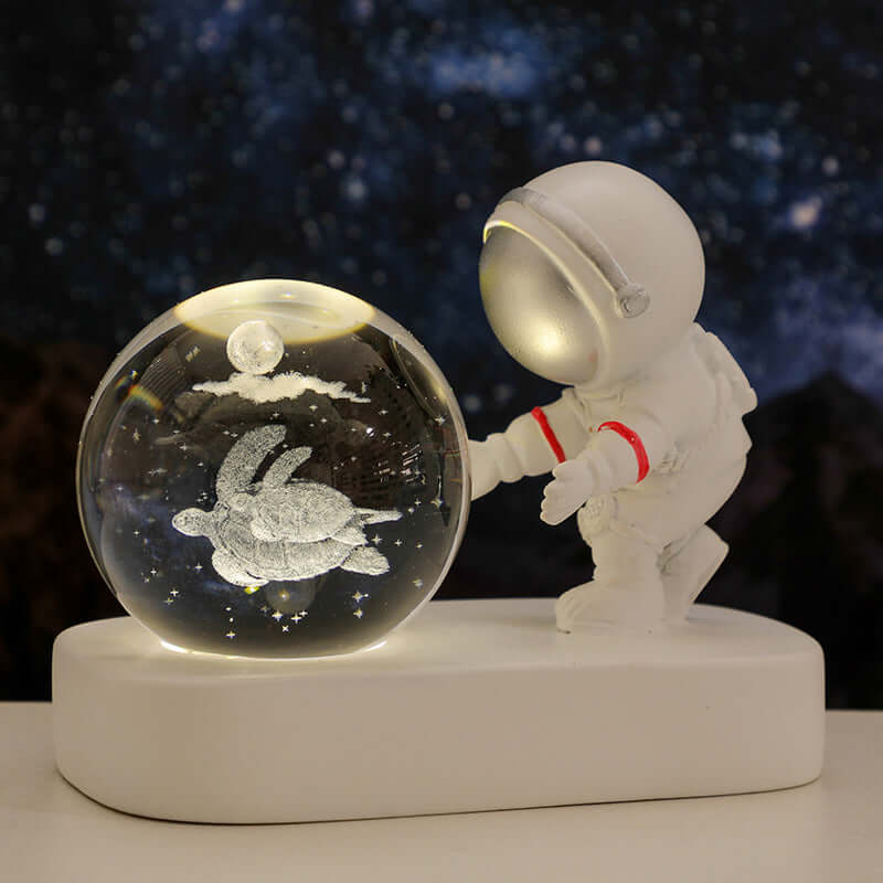 Astronaut figurine with a glowing crystal ball featuring a turtle, ideal for warm bedside lighting and gifts.