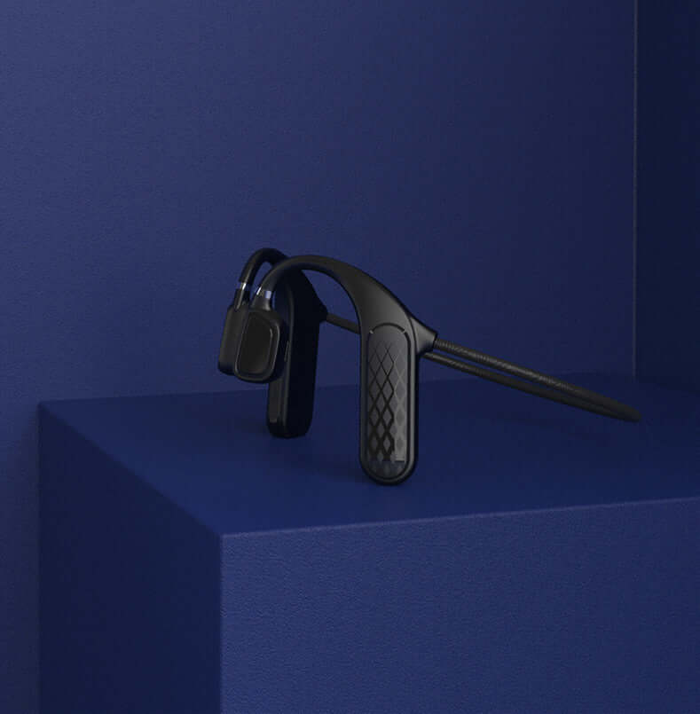 Bone conduction true wireless ear-mounted headphones in sleek black design on a blue surface.