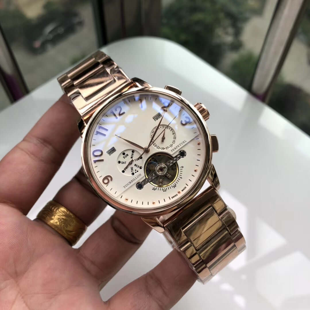Big flywheel mechanical watch featuring a round stainless steel case and a sleek dial with small three needles.