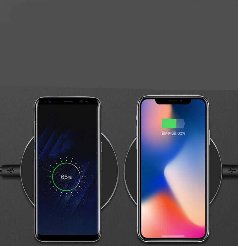 Wireless fast charger in use with two smartphones showing charging progress.