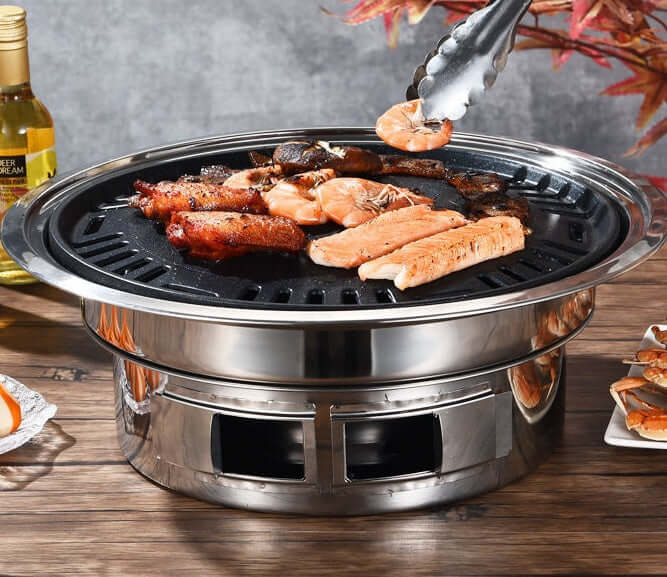 Korean stainless steel charcoal barbecue grill with shrimp and meat grilling, perfect for consumer and commercial use.