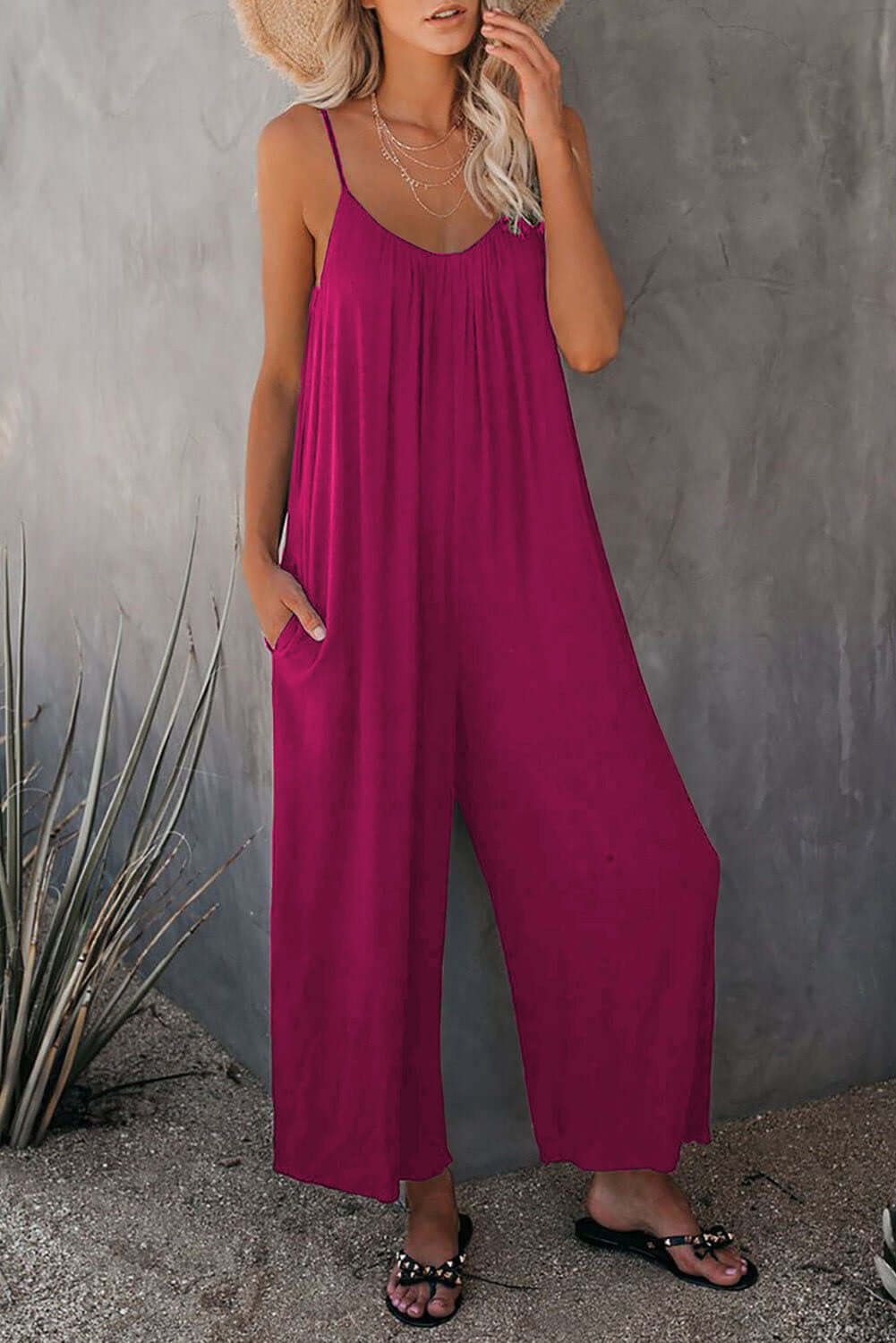 Women's loose sleeveless jumpsuit in fuchsia with pockets, perfect for summer casual style.