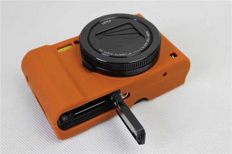 Silicone soft case camera bag in orange, designed for single electric cameras, featuring shockproof and breathable properties.