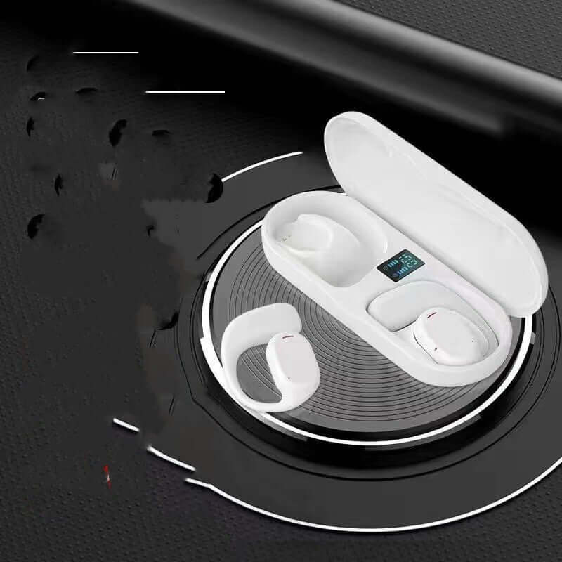 White wireless sports headphones in charging case on circular surface, featuring digital display for battery life.