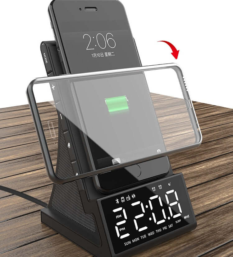 Bluetooth charging alarm clock radio with a smartphone charging on stand, displaying time and date.