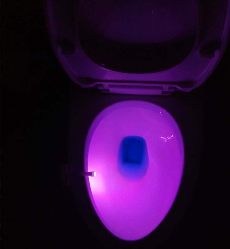 Toilet with glowing purple LED night light, featuring motion sensor for hygienic and modern convenience.