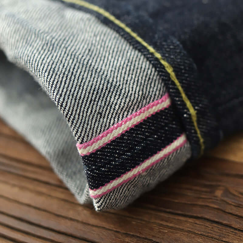 Close-up of cuff detail on thickened dark indigo denim casual pants for men, featuring contrast stitching.