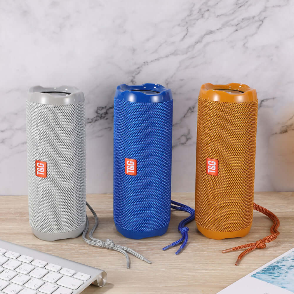 Fabric portable creative Bluetooth speaker in silver, blue, and orange with card holder.