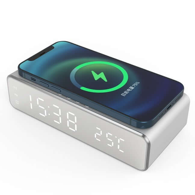 Wireless charging alarm clock with time display and thermometer, smartphone charging on top.
