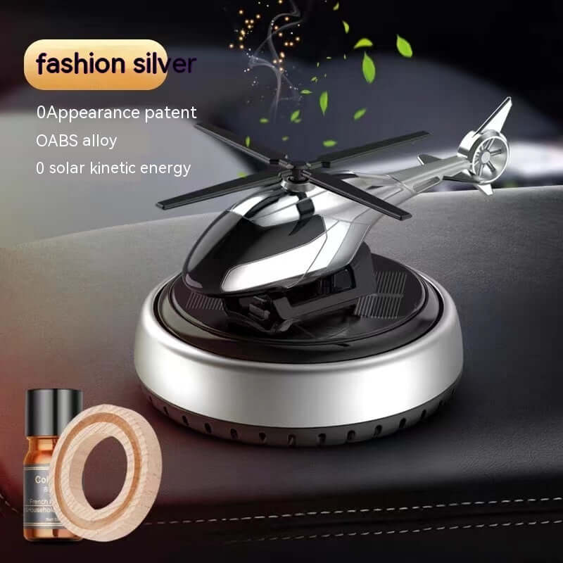 Sleek silver helicopter car perfume holder with solar energy, featuring aromatic oils and stylish design for décor.