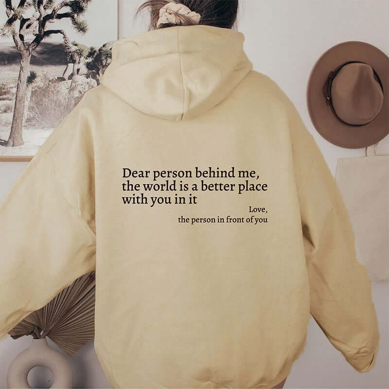 Beige unisex hoodie with letter print saying 'Dear person behind me, the world is a better place with you in it'