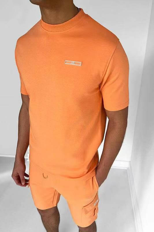 Men's casual orange T-shirt and shorts set, perfect for sports and outdoor activities, made from comfortable cotton blend.