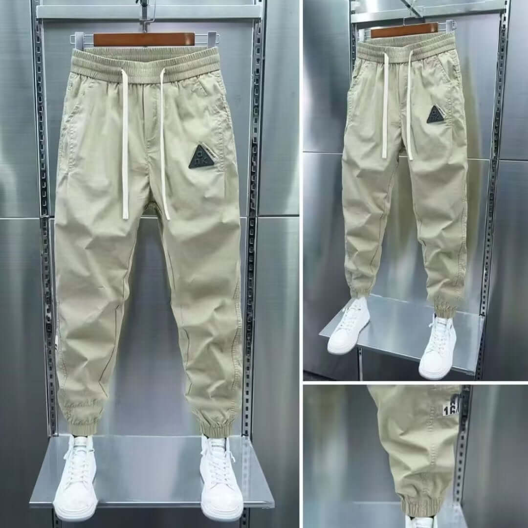 Men's leisure cropped pants in beige with ankle band and drawstring, perfect for summer casual wear.