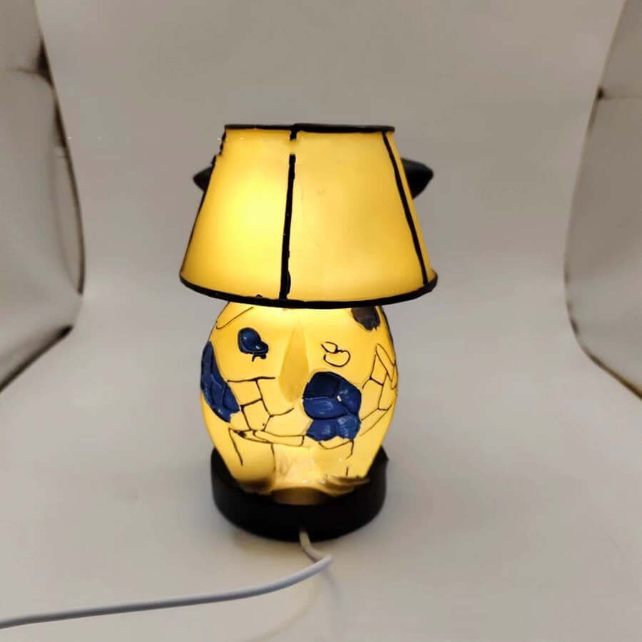 Vintage cow table lamp with fabric lampshade, perfect for bedroom or living room decor.