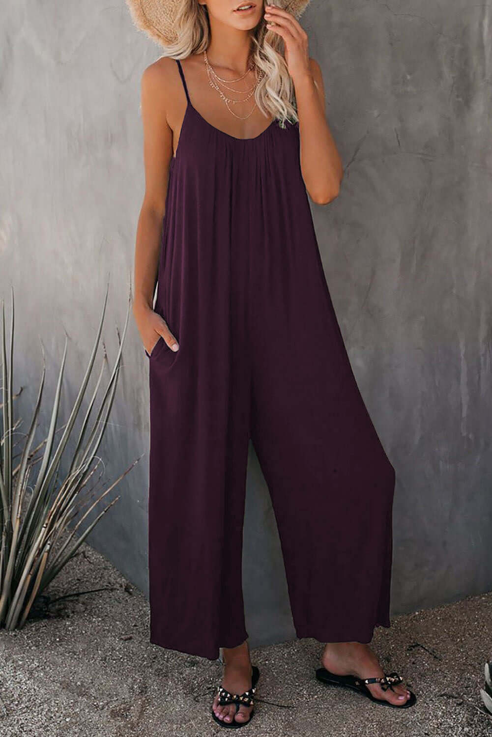 Women's loose sleeveless jumpsuit in purple with pockets, perfect for summer casual wear.